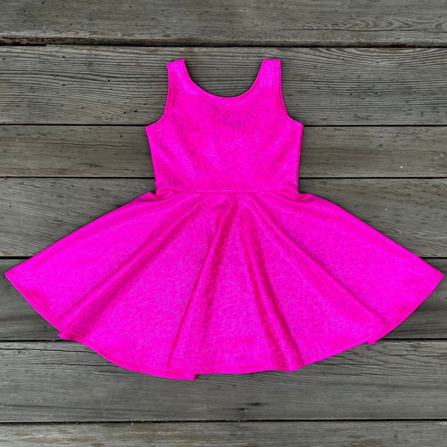 Pink dress on a wooden surface